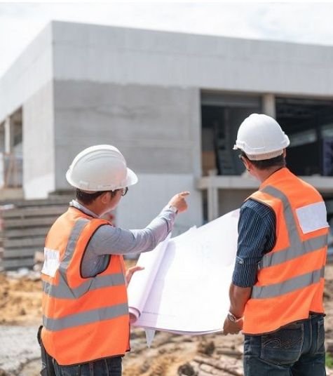Site engineer reviewing building drawings