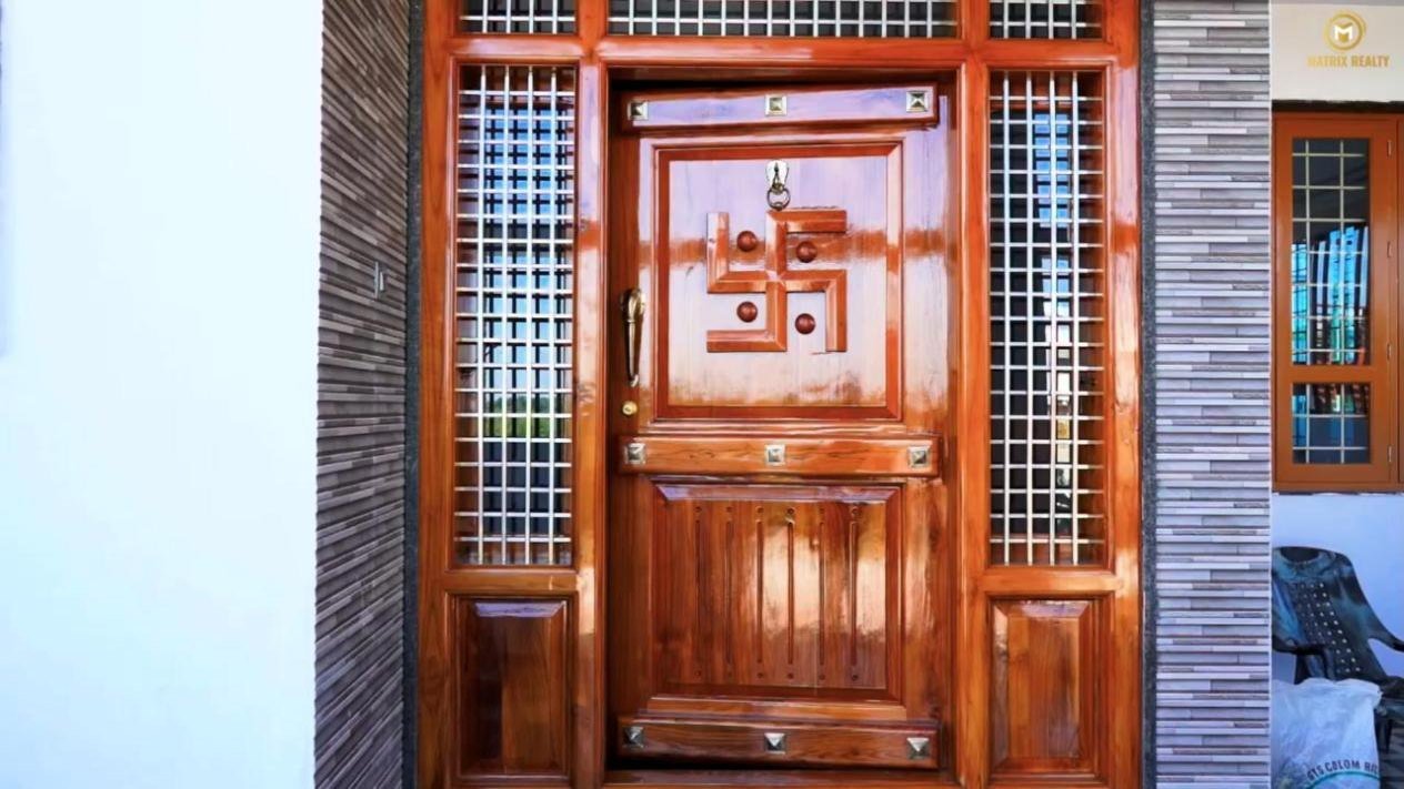 Polished teak main door in a Matrix Realty home