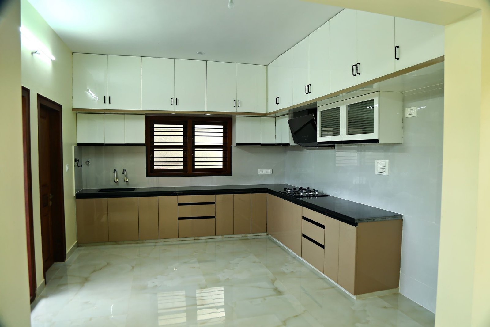 L-shaped modular kitchen with granite counter and chimney, interior work by Matrix Realty