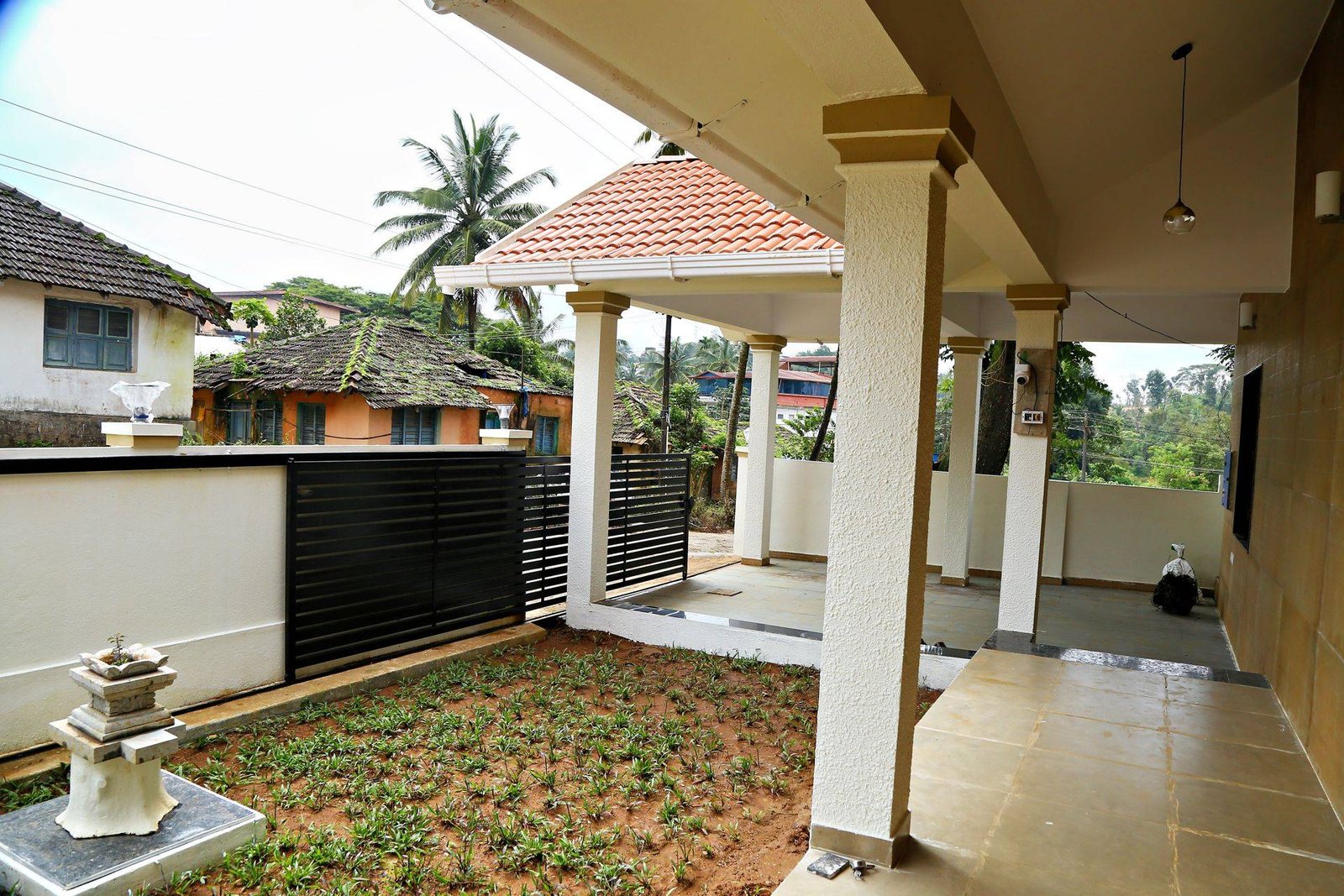 Sit-out verandah, garden and covered car parking with tiled roof